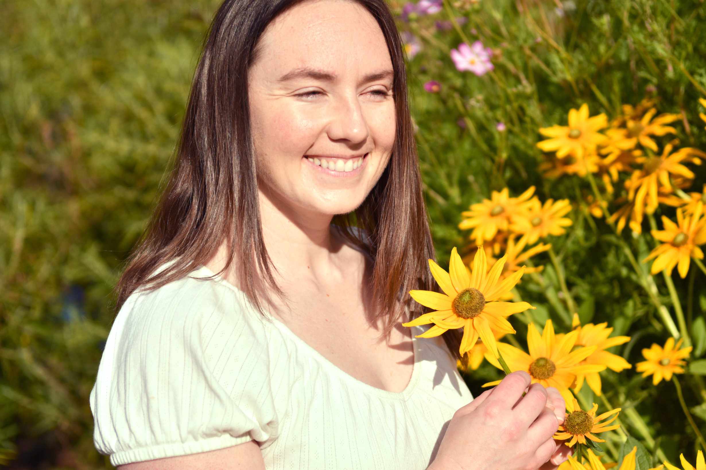 Anne is looking at yellow flowers